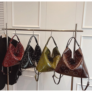 Glossy patent leather hobo bags in four colors with dot circular patterns and straps