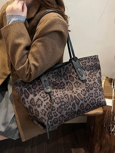 Chic leopard print large tote bag with black leather handles for stylish daily commuting