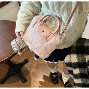 Détail du sac à main rose en fausse fourrure montrant la texture et le fermoir argenté