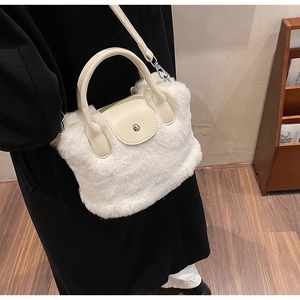 Détail du sac bandoulière en fausse fourrure blanche avec finitions en cuir crème
