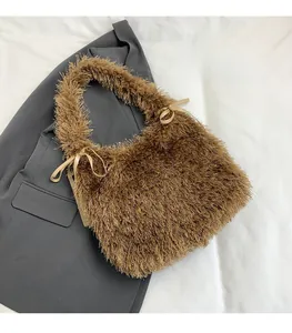 Detail of plush brown tote bag featuring soft faux fur texture and satin side bows