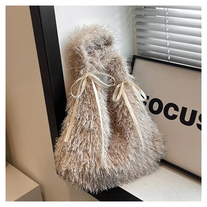 Detail of plush beige faux fur tote bag featuring elegant satin bow handle accents