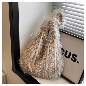 Detail of cream plush tote bag featuring elegant silk bow accents and soft faux fur texture