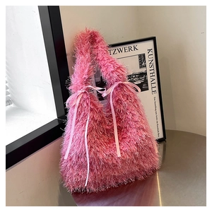 Detailed macro view of the pink faux fur texture and satin bows on the stylish tote bag