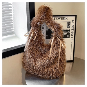 Detail of camel plush tote bag with long faux fur texture and white ribbon bows