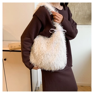 White fringe fuzzy shoulder bag with silk ribbon bow accessory shown in daily outfit