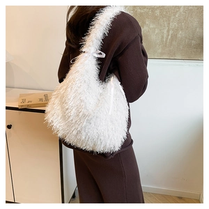 Detail of white fluffy faux fur tote bag featuring a decorative silk bow and long plush texture