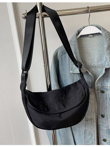 Black nylon crescent hobo bag with adjustable shoulder strap and embroidery