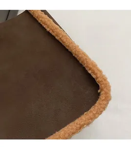 Detail of brown faux suede texture and soft shearling trim on the winter shoulder bag
