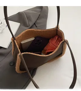 Top view of spacious brown faux suede shoulder bag showing phone and umbrella interior