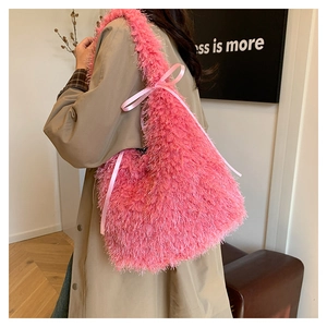 Detailed back view of a pink faux fur tote bag with satin bow on a beige coat