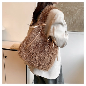 Brown fluffy tote bag with tassels and gold ribbon bow shown in a side-view pose