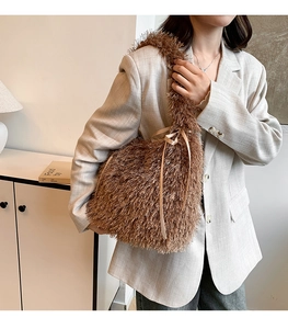 Detailed close-up of brown plush tote bag featuring soft faux fur and silk bow accent