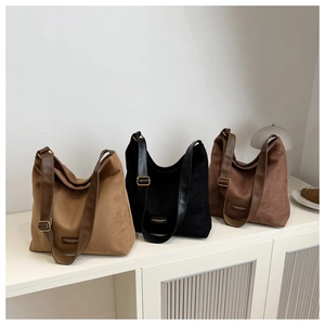 Three large suede shoulder bags in khaki, black and brown with wide leather straps