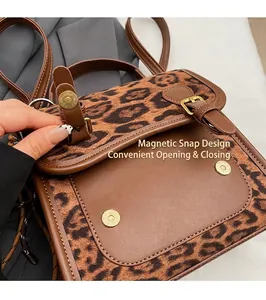 Detail of the magnetic snap closure on the leopard print tote bag for easy opening