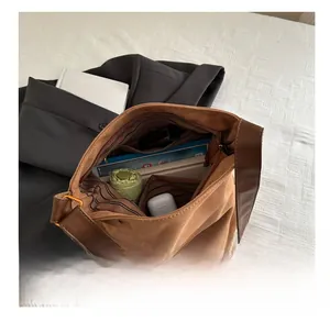 Interior view showing the large capacity and striped lining of this brown suede tote bag