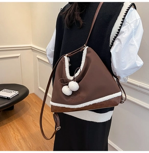 Detail of vintage brown shoulder bag featuring plush sheepskin trim and bow decoration