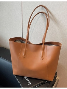 Minimalist large brown tote bag in smooth synthetic leather with dual long shoulder straps