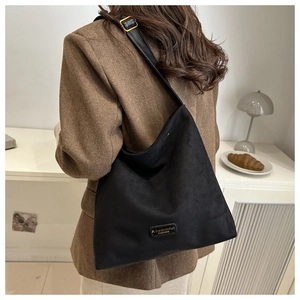 Detail of adjustable black leather strap with gold buckle on a matte vintage tote bag