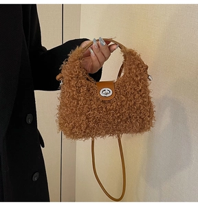 Detail of plush brown shearling handbag with leather handle and silver metal turn-lock