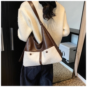 Detail of winter crossbody bag featuring brown faux leather and white plush fleece texture