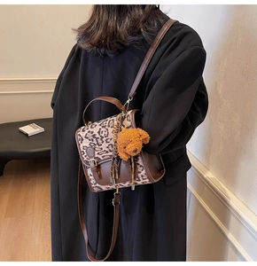 Chic leopard print crossbody bag with brown leather trim and cute plush bear charm