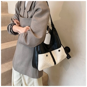 Hobo shoulder bag featuring black PU leather and white plush shearling contrast detail