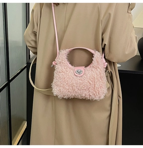 Pink plush faux fur crossbody bag with silver twist lock shown on a model