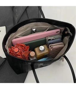 Top view of large black tote bag showing spacious interior with tablet and daily essentials