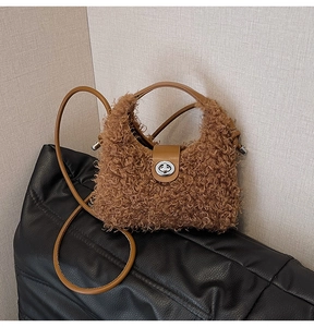 Detail of brown plush crossbody bag featuring sheepskin texture and silver metal twist lock