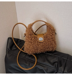 Detail of plush teddy handbag with leather twist lock and adjustable shoulder strap