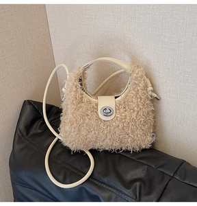 Detailed shot of beige plush crossbody bag with silver twist lock and leather strap