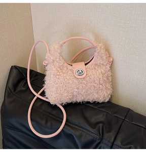 Pink plush crossbody bag with furry lamb-wool texture and silver metal twist lock closure