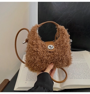 Detail of plush brown faux fur bag with leather straps and silver twist lock closure