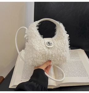 Close-up of white plush crossbody bag with leather handle and metallic rotating lock detail