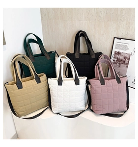 Collection of quilted tote bags in five colors with adjustable black shoulder straps