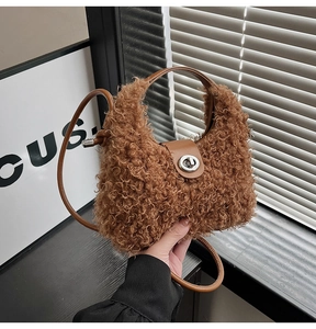 Detail of plush brown teddy fleece handbag with leather handles and metal twist lock