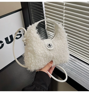Close-up of white plush lamb wool handbag featuring silver metal twist lock and ring handle