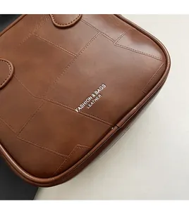 Detailed close-up of dark brown quilted leather texture and silver logo on the handbag