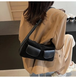 Detail view of the black matte suede hobo bag with front pockets and adjustable strap