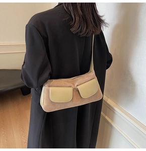 Detail of a vintage khaki frosted suede shoulder bag with cream contrast pockets