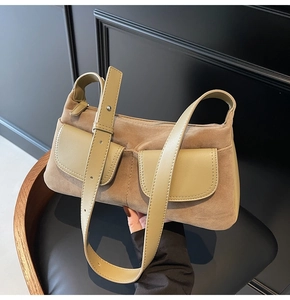 Detail view of khaki and olive green suede shoulder bag with retro leather texture