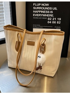 Off-white oversized tote bag with wave texture and cute monster plush pendant