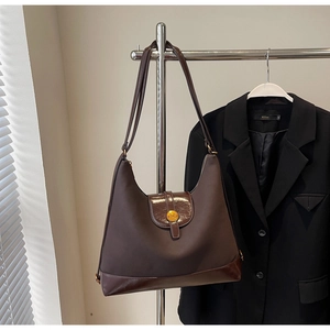 Deep brown hobo shoulder bag with glossy patent leather trim and golden metal N buckle