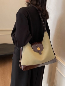 Green and brown patchwork canvas tote bag with gold N logo buckle for daily commute