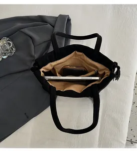 Top view of large capacity black tote bag interior with zipper pocket and lining