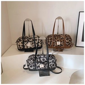 Fashionable leopard print faux fur Boston handbag with leather trim and dual strap style