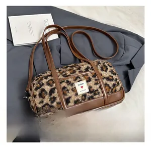 Detail of leopard print faux fur Boston bag with leather trim and adjustable shoulder strap