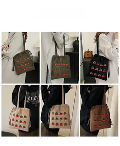Collage of canvas bucket bags with cherry embroidery and tassels in four colors
