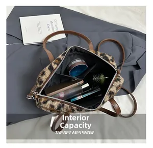 Spacious interior of leopard print plush bag showing storage for makeup and essentials